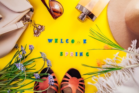 Spring female outfit. Set of clothes, shoes and accessories on yellow background. Welcome springの写真素材