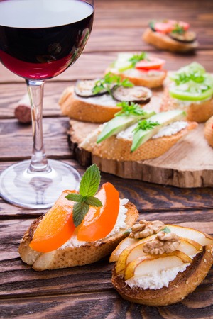 Brushetta set for wine. Variety of small sandwiches on wooden backgroundの写真素材