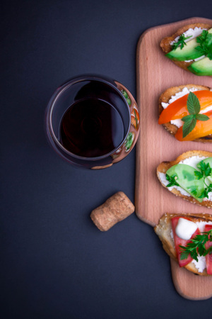 Brushetta set for wine. Variety of small sandwiches on black backgroundの写真素材
