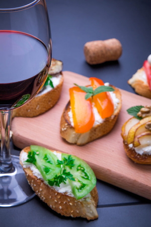 Brushetta set for wine. Variety of small sandwiches on black backgroundの写真素材