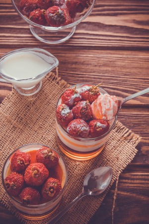 Layered jelly dessert with strawberries on wooden tableの写真素材