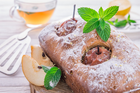 Cake with pears and mint on wooden backgroundの写真素材