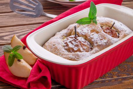 Cake with pears and mint on wooden backgroundの写真素材