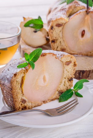 Cake with pears and mint on wooden backgroundの写真素材