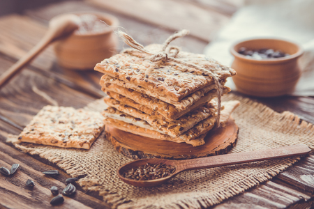 Healthy biscuits with grains and seeds on wooden tableの写真素材