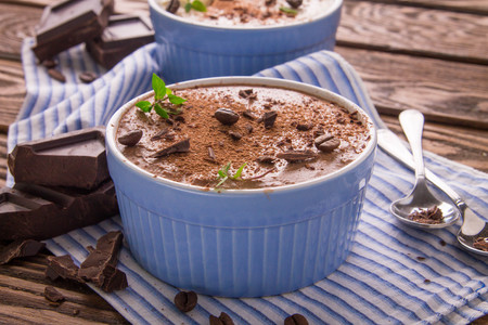 Cheese mousse with mint and cinnamon on wooden backgroundの写真素材