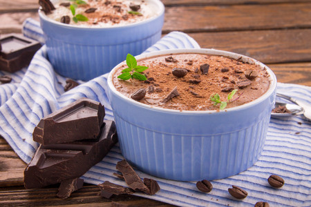 Cheese mousse with mint and cinnamon on wooden backgroundの写真素材