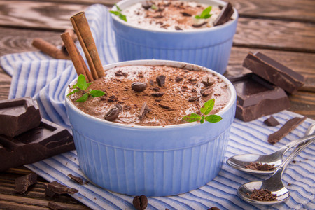 Cheese mousse with mint and cinnamon on wooden backgroundの写真素材