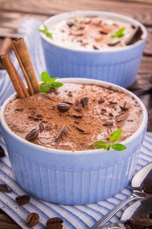 Cheese mousse with mint and cinnamon on wooden backgroundの写真素材