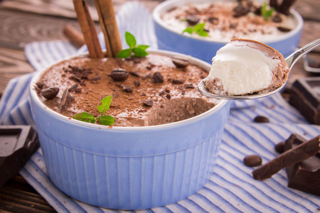 Cheese mousse with mint and cinnamon on wooden backgroundの写真素材