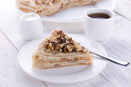 Napoleon and coffee for breakfast on wooden tableの写真素材