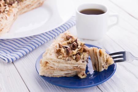 Napoleon and coffee for breakfast on wooden tableの写真素材