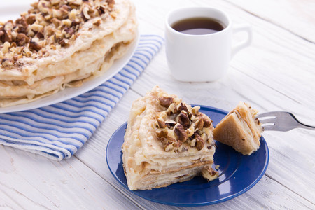 Napoleon and coffee for breakfast on wooden tableの写真素材