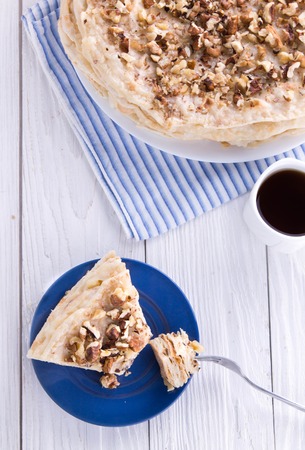 Napoleon and coffee for breakfast on wooden tableの写真素材