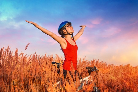 Young bicyclist riding in the fieldの写真素材