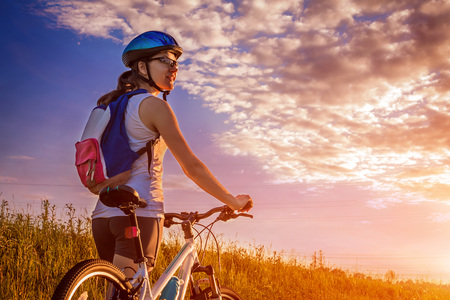 Young bicyclist riding in the fieldの写真素材