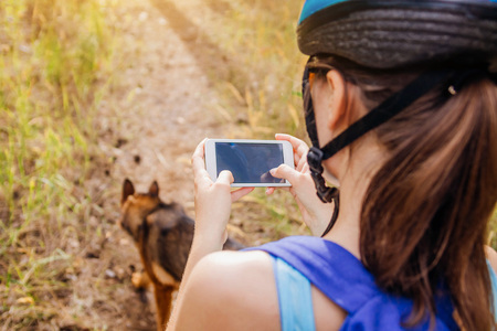 Young bicyclist searching for the right way using a navigator on her phoneの写真素材