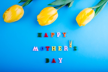 Happy Mothers day. Lettering with yellow tulipsの写真素材