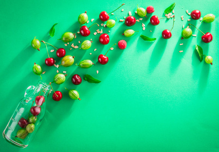 Juice ingredients in glass bottle on green backgroundの写真素材