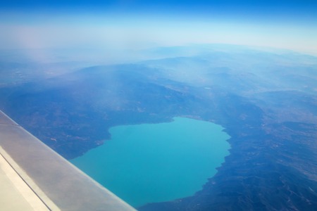 Plane window view of Iznik lake surrounded with mountains, Turkeyの写真素材