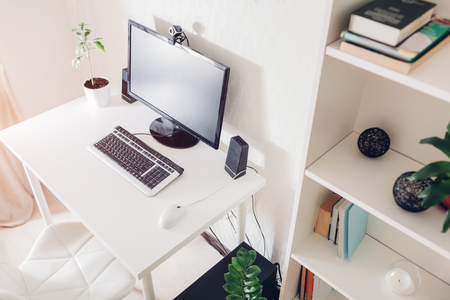 Work from home. Workspace of a freelancer. Interior. Modern design with white furniture, accessories and technologies.の写真素材