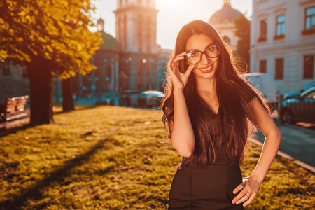 Beautiful businesswoman poses outdoors. Middle-eastern woman smiling on city street. conceptの写真素材