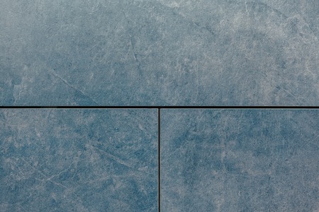 Texture of grey stone wall. Blue background divided on three blocksの写真素材