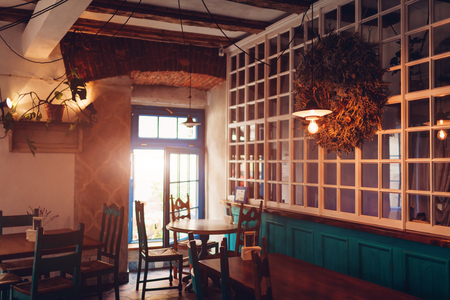 Interior of loft bar. Vintage design of cafe. Retro style restautant with vintage furnitureの写真素材