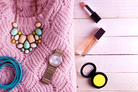 Female outfit on wooden background. Set of clothing, cosmetics and accessoriesの写真素材