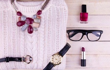 Female outfit on wooden background. Set of clothing, cosmetics and accessoriesの写真素材