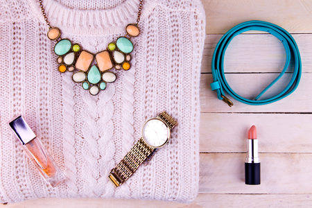 Female outfit on wooden background. Set of clothing, cosmetics and accessoriesの写真素材