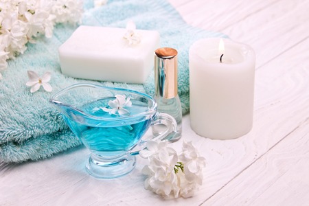 Spa setting and health care items, body lotion, soap, candles, oil, towel with lilac. Body careの写真素材
