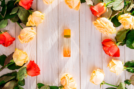 Perfume bottle with roses on wooden background. Organic cosmeticsの写真素材