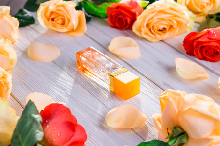 Perfume bottle with roses on wooden background. Organic cosmeticsの写真素材