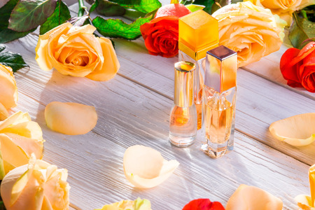 Perfume bottles with roses on wooden background. Natural cosmeticsの写真素材