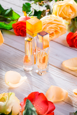 Perfume bottles with roses on wooden background. Natural cosmeticsの写真素材