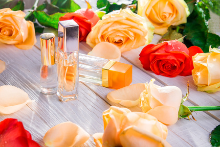 Perfume bottles with roses on wooden background. Natural cosmeticsの写真素材