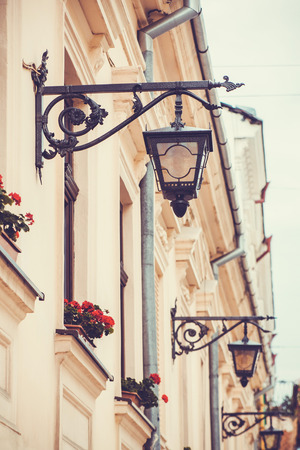Old building in European city with flowers and lampsの写真素材