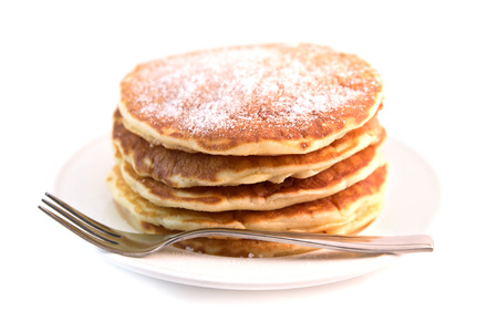Stack of pancakes with sugar powder isolated on white background. Tasty dessertの写真素材
