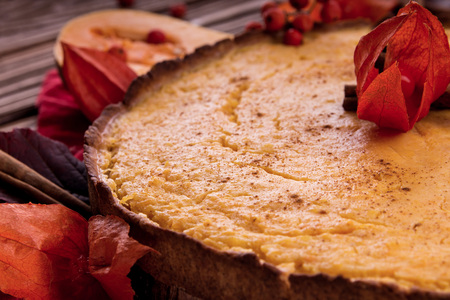 Pumpkin pie with berries and cinnamon. Autumn dessert on wooden table. Foodの写真素材