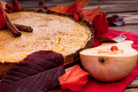 Pumpkin pie with berries and cinnamon. Autumn dessert on wooden table. Foodの写真素材