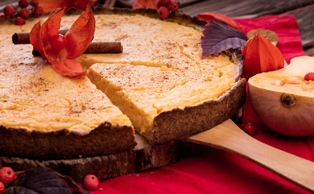Pumpkin pie with berries and cinnamon. Autumn dessert on wooden table. Foodの写真素材