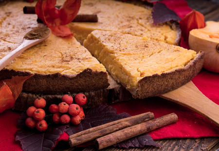 Pumpkin pie with berries and cinnamon. Autumn dessert on wooden table. Foodの写真素材
