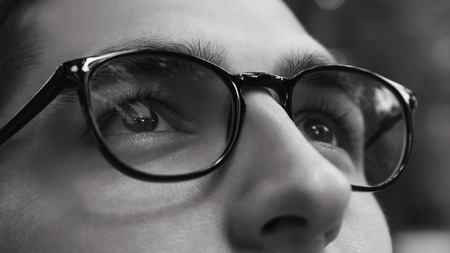 Close-up of man wearing glasses. Black and white life without sight. Healthy sight concept.の写真素材