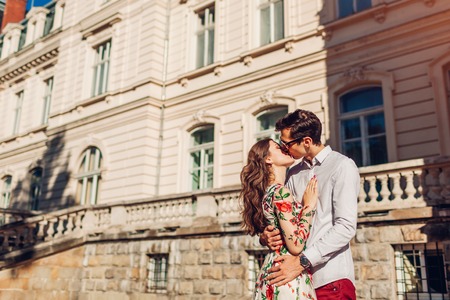 Young happy couple in love hugging and kissing outdoors. Romantic relationships. Man and woman walking in Lvivの写真素材