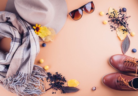 Autumn female outfit. Set of clothes, shoes and accessories on brown background. Copy spaceの写真素材
