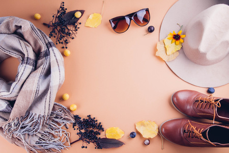 Autumn female outfit. Set of clothes, shoes and accessories on brown background. Copy spaceの写真素材