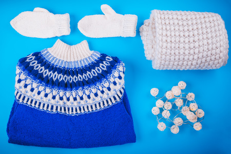 Winter female outfit. Set of clothes and accessories on blue backgroundの写真素材