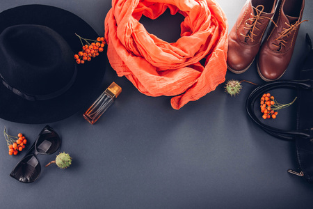 Autumn female outfit. Set of clothes, shoes and accessories on grey background. Copy spaceの写真素材