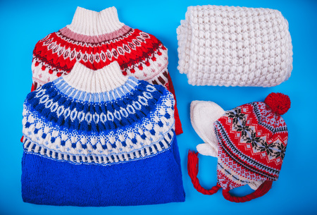 Winter female outfit. Set of clothes and accessories on blue backgroundの写真素材